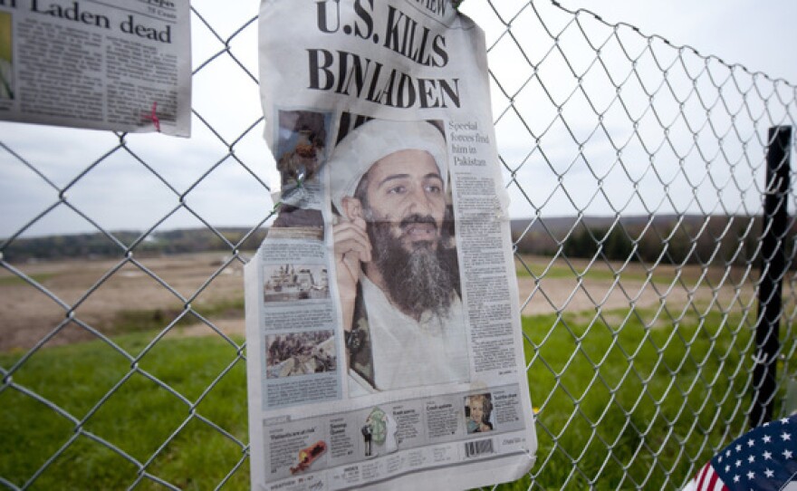 A newspaper left by visitors on May 2 in Shanksville, Pa., at the fence surrounding the crash site of Flight 93. The chairmen of the 9/11 Commission say the U.S. has improved security over the past decade, but gaps in the system remain.