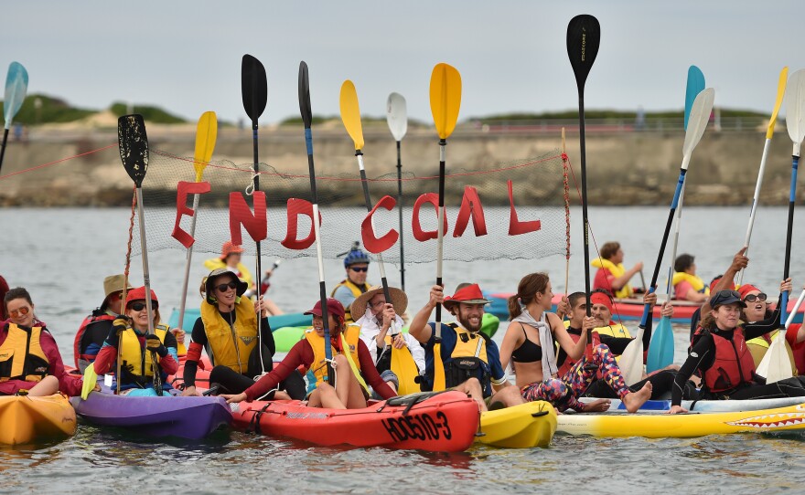 A group of protesters shout as they block shipping access to Australia's largest coal port in Newcastle during a demonstration against coal and fossil fuels on May 8.