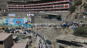 Voters line up outside a polling station during general elections in Lima, Peru, Sunday, April 12, 2026.