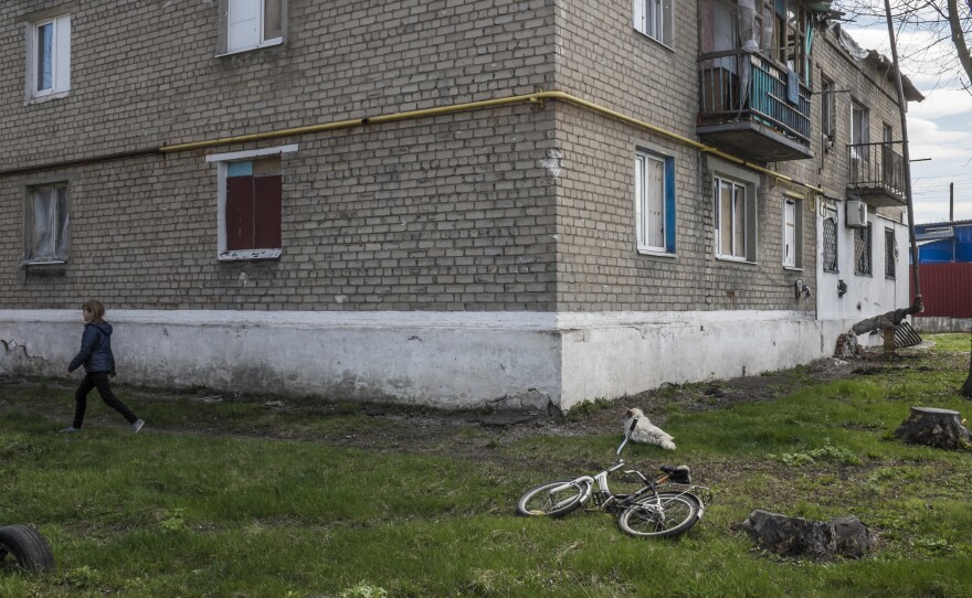 Vika, 10, walks in the yard near where she lives in Spartak, Ukraine. Despite some of the heaviest fighting of the war taking place close by and regular shelling of the neighborhood, Vika has remained in Spartak throughout the conflict.