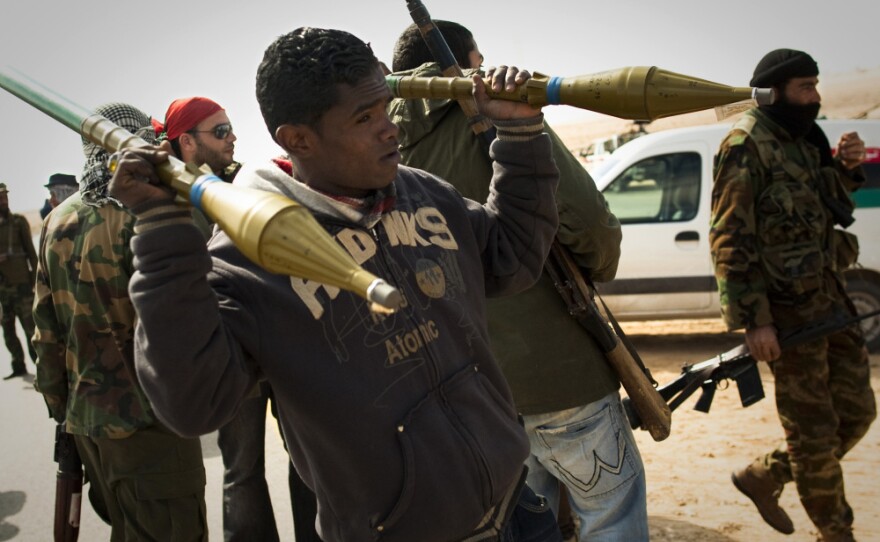 Rebels carry rockets on a checkpoint on the front line near Zwitina, the outskirts of the city of Ajdabiya, south of Benghazi, eastern Libya, on March 24.