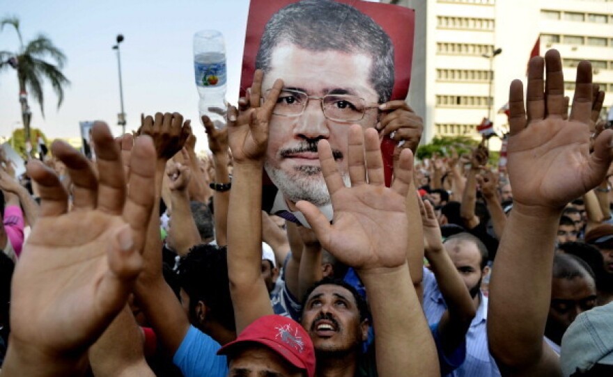 Egyptian supporters of the Muslim Brotherhood hold pictures of deposed President Mohammed Morsi in Cairo on Friday.
