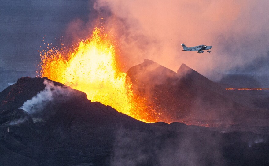 A plane flies over the Bardarbunga volcano as it spews lava and smoke in southeast Iceland on Sept. 14. The Bardarbunga volcano system has been rocked by hundreds of tremors a day since mid-August, prompting fears the volcano could explode.