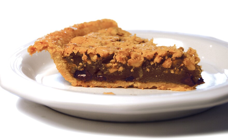 A slice of Derby-Pie® from Kern's Kitchen. The Kern family is said to have created the pie in 1950 as the signature item for a restaurant they used to operate. What people commonly call "derby pie" is like an embellished pecan pie: sticky, sweet filling made with bourbon and chocolate chips. Ironically, Kern's recipe is made without bourbon, and it uses walnuts instead of pecans.