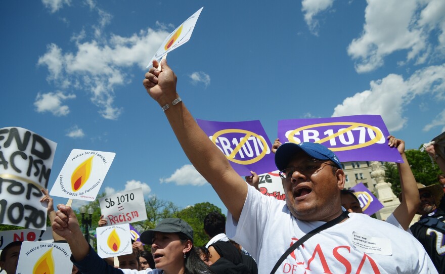 Protesters outside the U.S. Supreme Court shout slogans during an April 25 protest against Arizona Senate Bill 1070.