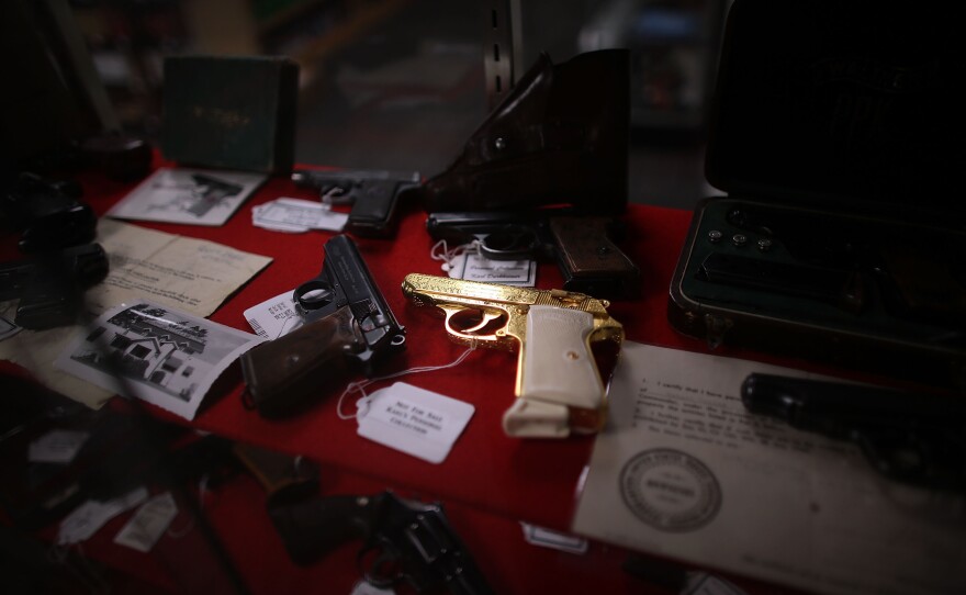 A gold pistol sits at the center of a display of rare and collectible handguns Tuesday at Northwest Armory in Portland, Ore. The high-end gun store sells handguns, hunting rifles and more to customers willing to go through a background check.