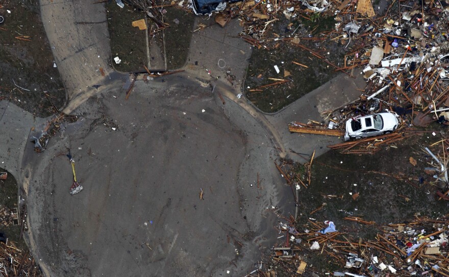 An aerial photo shows destroyed houses in Moore, Okla., after Monday's tornado. Rena and Paul Phillips, who lost their home in the storm, also lost a house to a tornado in 1999.