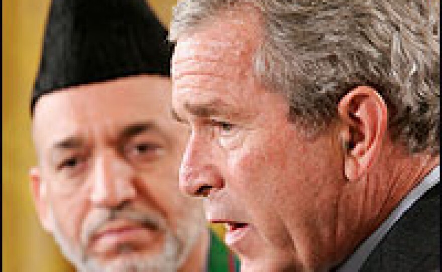 President Bush, with Afghan President Hamid Karzai, answers questions at a briefing. Bush is meeting with Karzai and Pakistan President Pervez Musharraf in Washington, D.C. to discuss the war on terrorism.