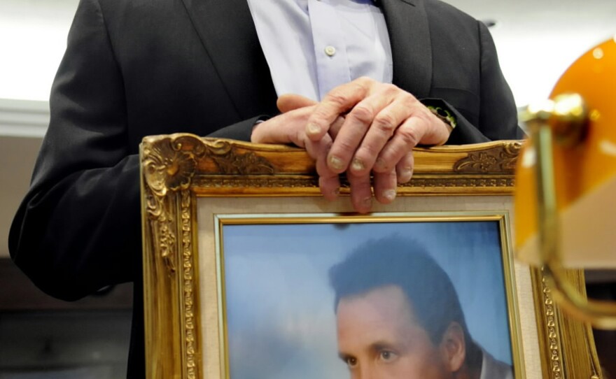 Neil Heslin brought a framed photo of himself and his son Jesse (when the boy was an infant) to Monday's hearing in Hartford, Conn. The 6-year-old was killed at Sandy Hook Elementary School in December's shooting.