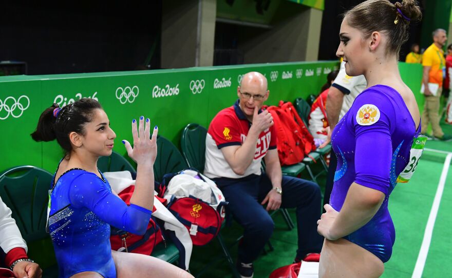 Russia's Aliya Mustafina (right) speaks with teammate Seda Tutkhalian at the women's individual all-around final of the Artistic Gymnastics.