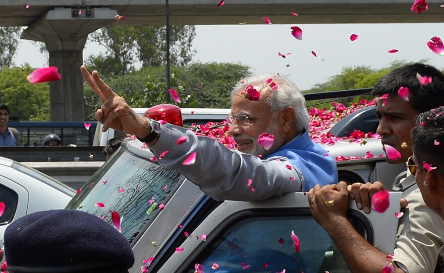 Hundreds of flag-waving supporters mobbed Indian Prime Minister-elect Narendra Modi as he arrived in New Delhi.