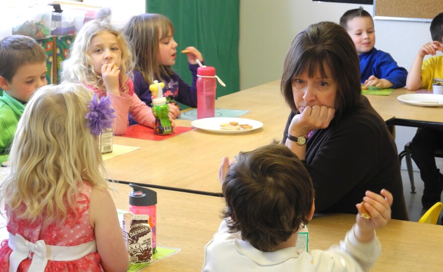 Idaho preschool teacher Mary Allen listens to one of her students during their afternoon snack time. The state doesn't have public preschool, so programs are paid for through a hodgepodge of funding sources.