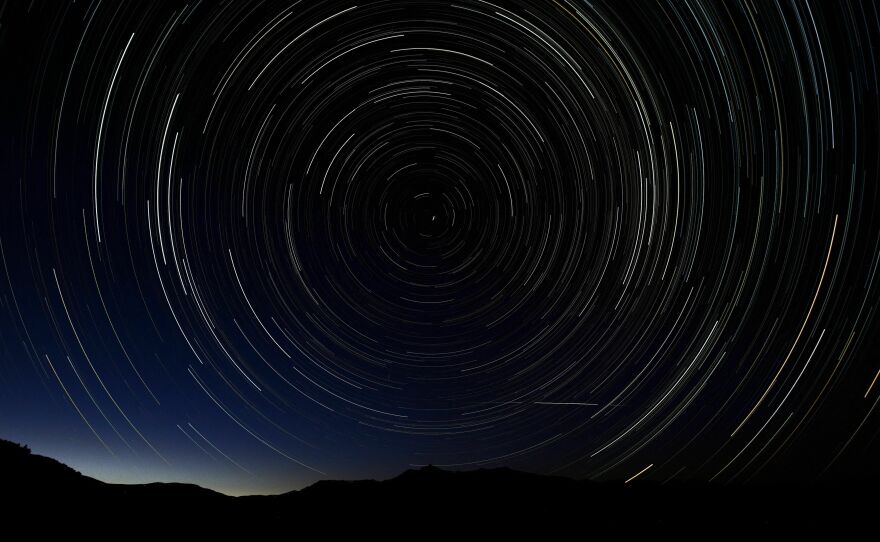 A multiple exposure picture taken in the early hours of August 11, 2013 shows a Perseids meteor shower in the sky on the mountains of the Sierra Norte de Madrid.