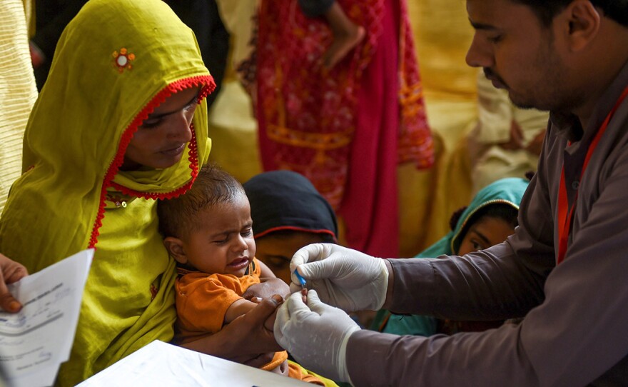 A paramedic takes a blood sample from a baby for an HIV test in Larkana, Pakistan, on May 9. The government has been offering screenings in response to an HIV outbreak.