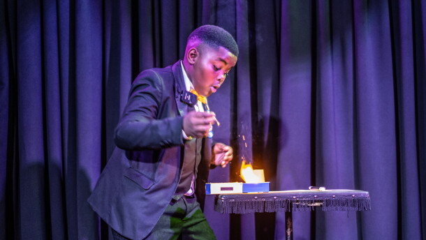Lubelo Mthenjana, who's 11, performs a magic trick involving fire during the annual junior magic contest at the College of Magic in Cape Town, South Africa.