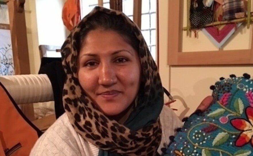 Zara Hosseini, 34, sells her embroidery in Riace. The Afghan migrant arrived in the southern Italian town three years ago.