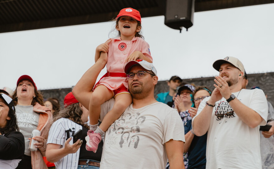A young fan dons a Rockford Peaches uniform — a nod to one of the All-American Girls Professional Baseball League's teams that inspired the 1992 film A League of Their Own — at opening day on Saturday, Aug. 1.
