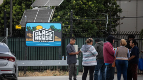 Families wait outside the front gates of the Glass House Farms facility outside Camarillo on July 11, 2025. Glasshouse Farms was the site of an immigration raid by federal immigration agents just a day prior, on July 10.