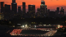 Motorists wait in lines to take a coronavirus test in a parking lot at Dodger Stadium, Monday, Jan. 4, 2021, in Los Angeles.