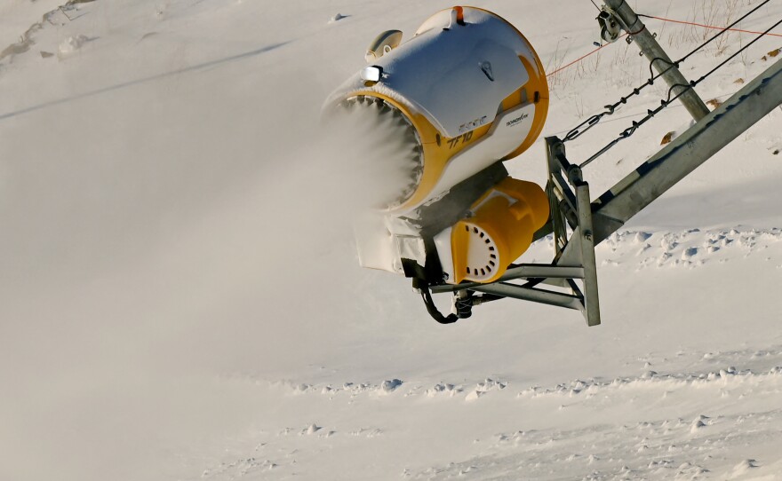 A snow machine spreads artificial snow at the National Alpine Skiing Center at the Beijing 2022 Winter Olympic Games.