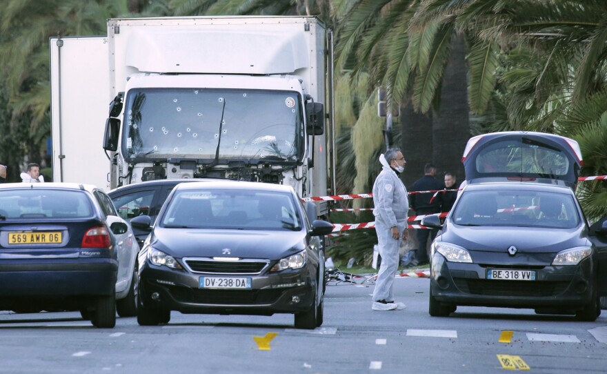 Forensic police investigate a truck at the scene of a terror attack on the Promenade des Anglais in Nice. The BBC reports that the truck traveled more than a mile through the crowd, with eyewitnesses saying it "swerved and zigzagged" as it went.