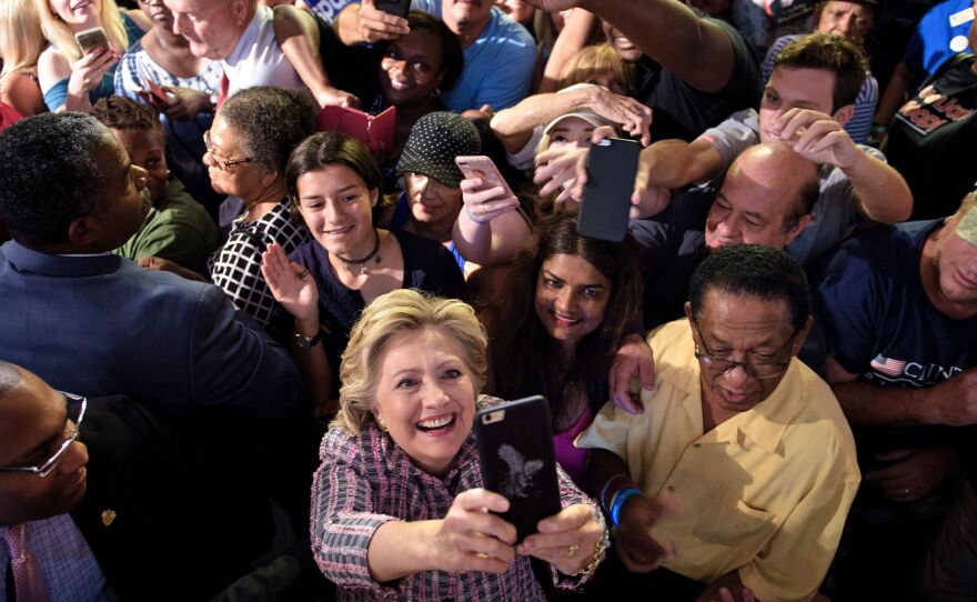 Democratic presidential nominee Hillary Clinton takes a selfie with supporters after speaking at a rally about national service Sept. 30 in Fort Pierce, Fla.