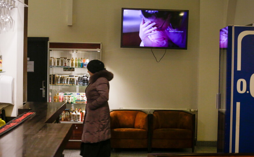 A refugee, recently arrived from Ukraine, walks the halls of the hotel.