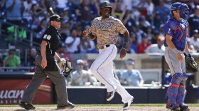 San Diego Padres' Cameron Maybin scores the winning run in the ninth inning of a 2-1 win against the New York Mets, July 20, 2014.