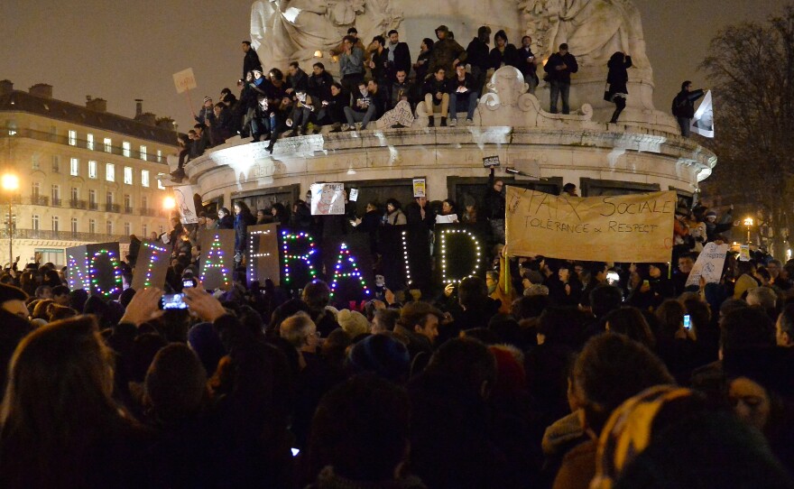 An estimated 5,000 people gather at the Place de la Republique to show solidarity after a terrorist attack Wednesday in Paris. Twelve people were killed, including two police officers; police are still looking for the two gunmen.