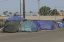 Tent encampments along the side of Sports Arena Blvd. in the Midway District of San Diego, CA on July 26, 2023.