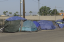 Tent encampments along the side of Sports Arena Blvd. in the Midway District of San Diego, CA on July 26, 2023. 