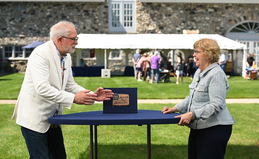Wes Cowan (left) appraises an 1864 Lincoln & Johnson campaign flag in Charlevoix, Mich. ANTIQUES ROADSHOW “Castle Farms, Hour 2” premieres Monday, April 6 at 8/7C PM on PBS.
