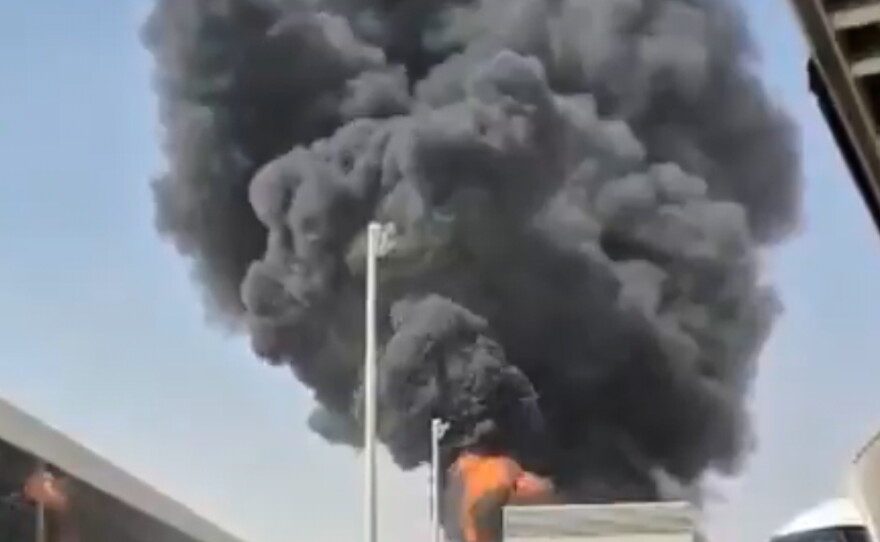 This image from video obtained and verified by AP shows thick black smoke and flames rising from a fire at King Khalid International Airport in Riyadh, Saudi Arabia, Friday, Oct. 9, 2026.