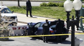 U.S. Capitol Police officers stand near a car that crashed into a barrier on Capitol Hill in Washington, Friday, April 2, 2021. 