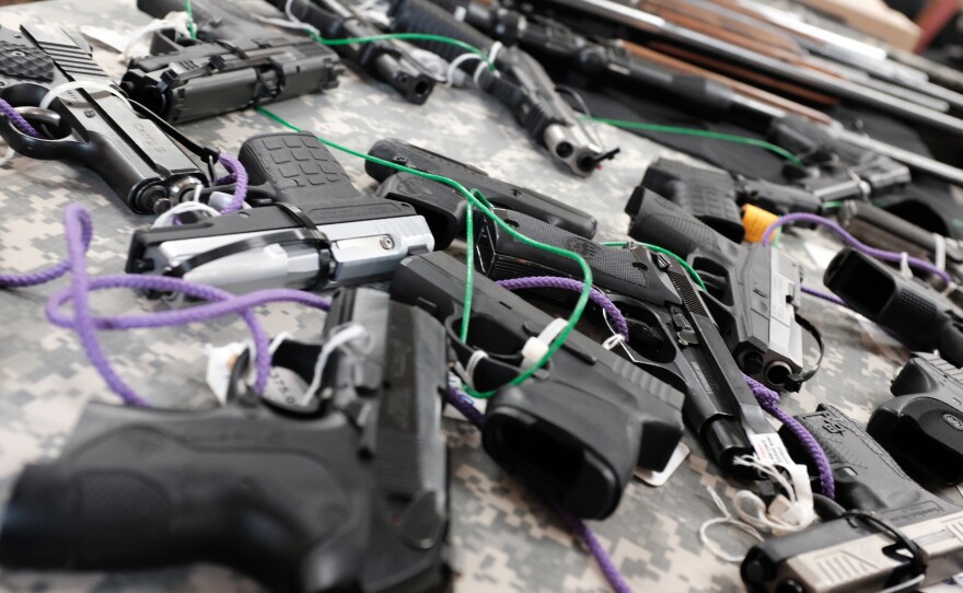 Guns for sale at a gun show in Naples, Fla.