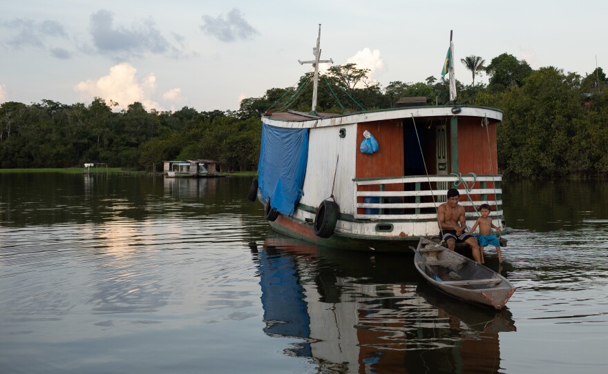 A father and son in a wooden boat on Lake Amanã on Nov. 16.