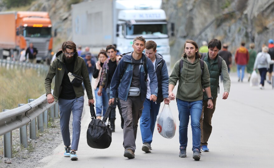Russians queue to leave their country to avoid a military mobilization, at the Kazbegi border crossing in Stepantsminda, Georgia, on Sept. 28. The number of Russian citizens entering Georgia increased after Vladimir Putin's partial mobilization order.
