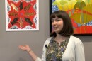 Student artist Maya Satterberg shows off her painting at The Studio Door's new #WeBorrowTheEarthFromOurChildren exhibit focused on climate change. March 16, 2022