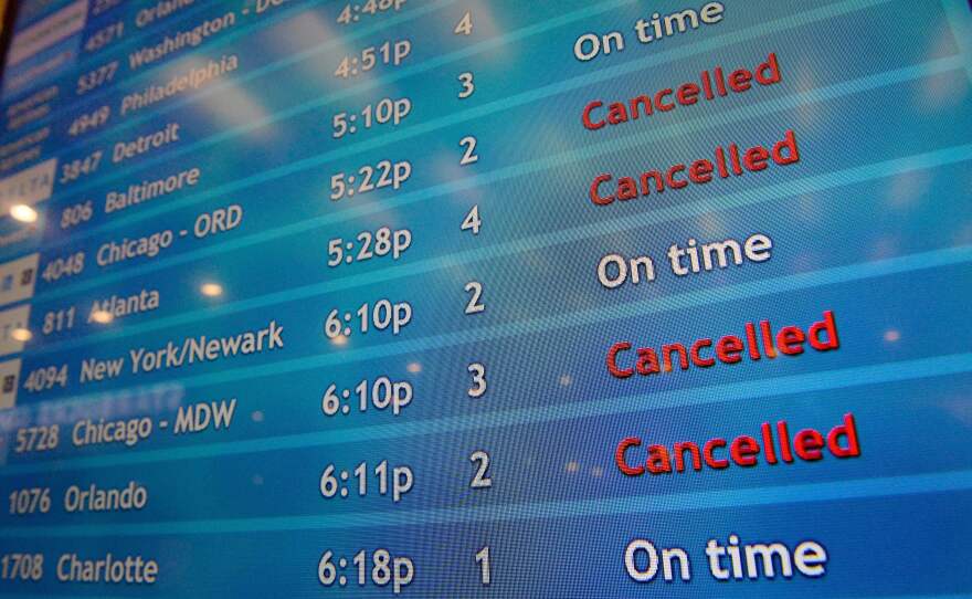 A screen shows canceled incoming flights at TF Green International Airport in Warwick, R.I. on March 30, 2020, during the novel coronavirus outbreak.