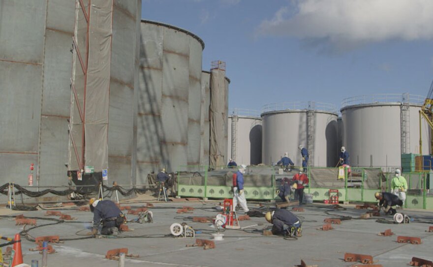 Workers welding storage tanks at Fukushima Daiichi, Japan.