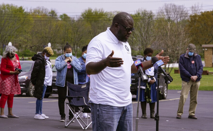 Pastor Denell Howard leads a prayer Saturday at a vigil at the Olivet Missionary Baptist Church in Indianapolis for the victims of the shooting Thursday at a FedEx facility.