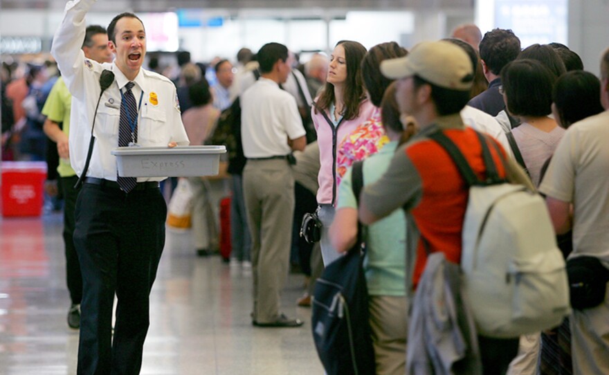 In this Aug. 10, 2006 file photo, Transportation Security Administration screener Patrick Reynolds shows items that are not allowed on flights to waiting airline passengers at the security checkin at San Francisco International Airport.