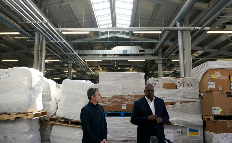 Pallets of aid to Ukraine are stacked behind Secretary of Defense Lloyd Austin (right) and Secretary of State Antony Blinken as they speak with reporters after returning from their trip to Kyiv, Ukraine, and meeting with Ukrainian President Volodymyr Zelensky, on Monday in Poland.