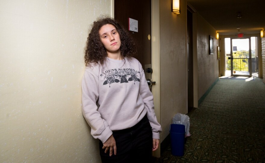 Sarah Hamidi, 22, a senior at UC Santa Barbara and a general anthropology major, stands in the hallway of the hotel where she’s been living this school year in this undated photo. With no kitchen, Hamidi makes meals in an instant pot or orders them online. 