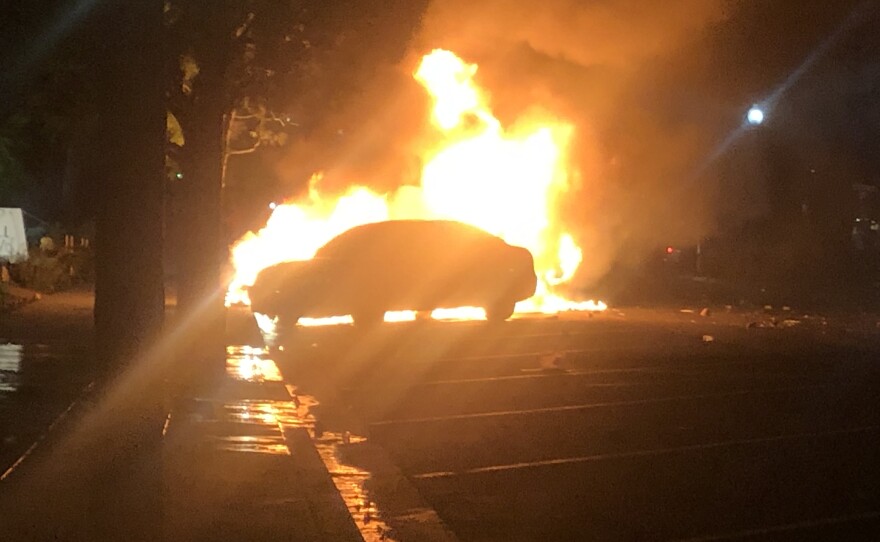 A car on fire during a protest in La Mesa, May 30, 2020.