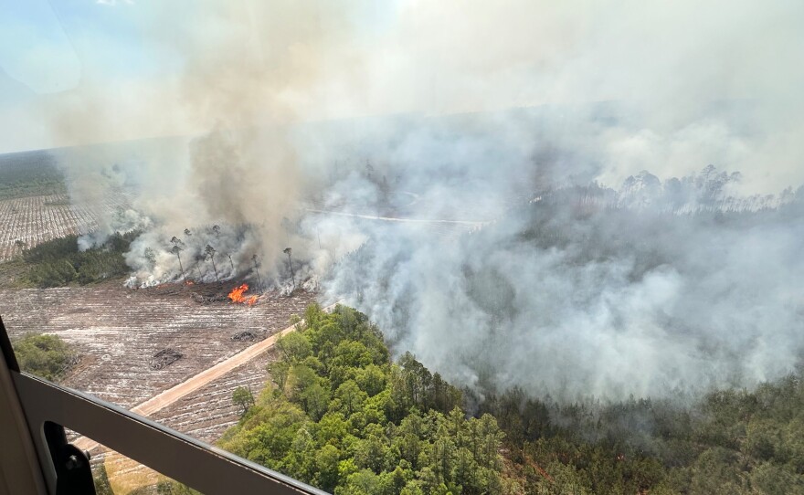 The photo provided by the Office of Gov. Brian Kemp shows smoke produced from a wildfire in Brantley County, Ga., Friday, April 24, 2026.