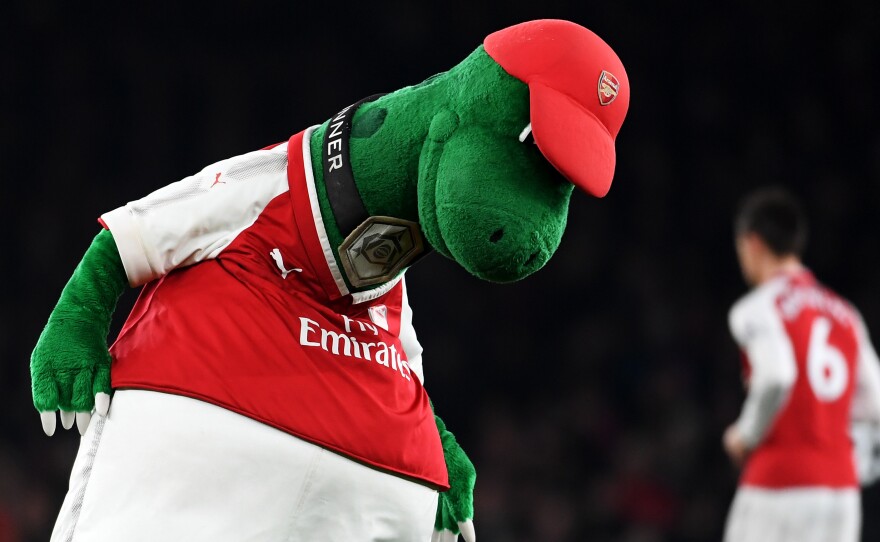 Gunnersaurus is seen warming up prior to a match at Emirates Stadium in 2017 in London. Jerry Quy, who played the team's mascot Gunnersaurus for 27 years, was recently told he would be let go.