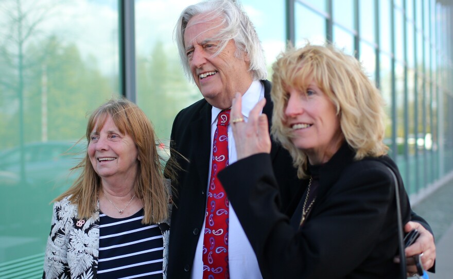 (From left) Margaret Aspinall of the Hillsborough Family Support Group, attorney Michael Mansfield and Yvette Greenway smile outside the courthouse after hearing the conclusions of the Hillsborough inquest Tuesday.