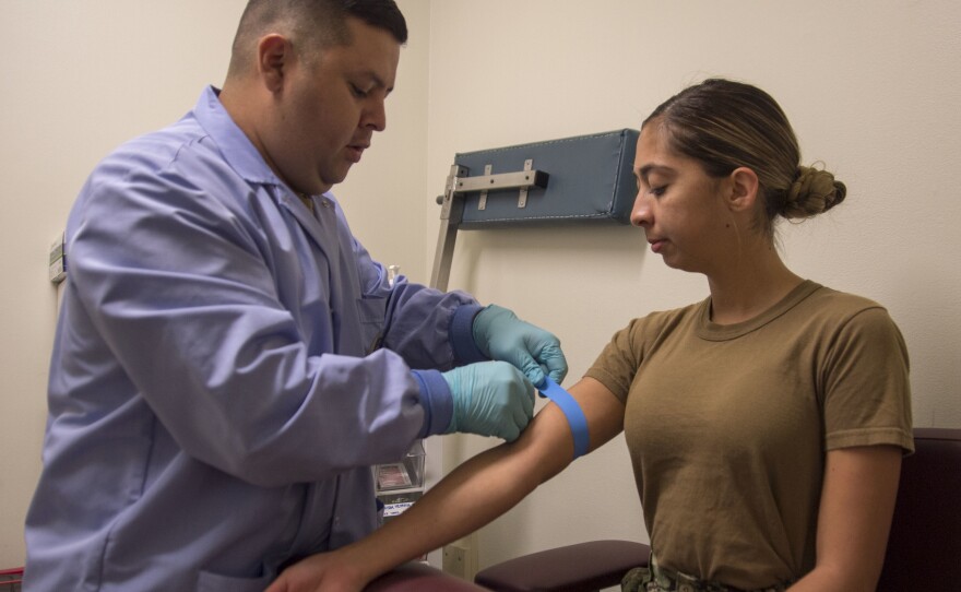 Hospital Corpsman 2nd Class Sergio Palacios, assigned to Naval Medical Center San Diego draws blood from Mass Communication Specialist 3rd Class Harley Sarmiento, August 7, 2019.