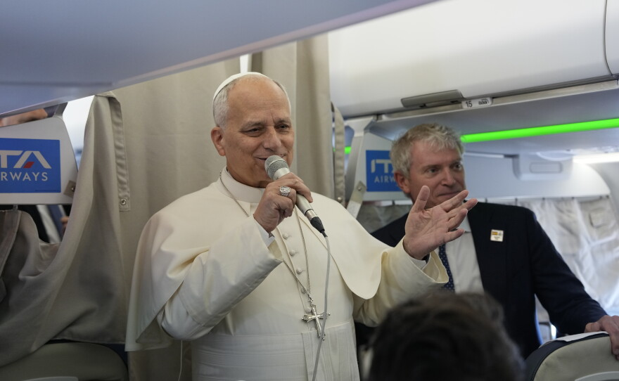 Pope Leo XIV talks to journalists aboard the papal flight from Rome to Madrid on June.